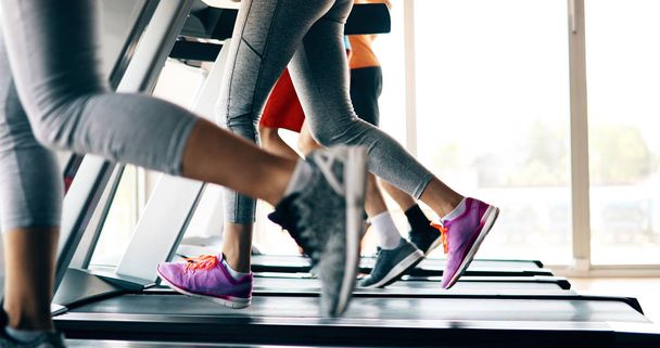 people running on treadmill in gym - Photo, Image