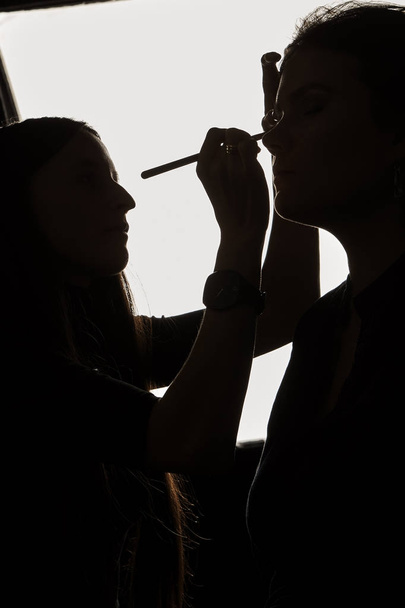 silhouette photo of makeup artist working - Photo, Image