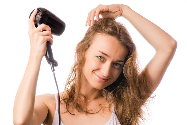 Beautiful young woman dries hair with a hairdryer beauty - Foto, Imagem