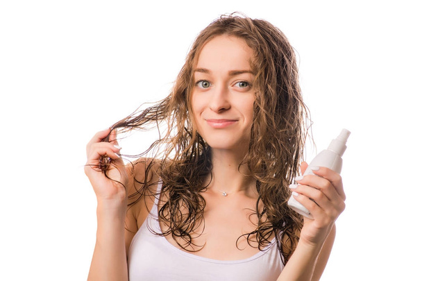 Beautiful young woman wet hair spray for hair isolated - Foto, Imagen
