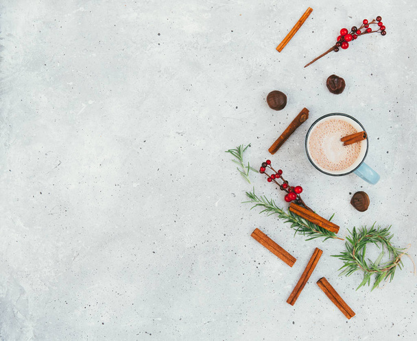 Christmas natural decorations and hot chocolate over vintage table. Holiday background. Copy space, flat lay. - Фото, зображення