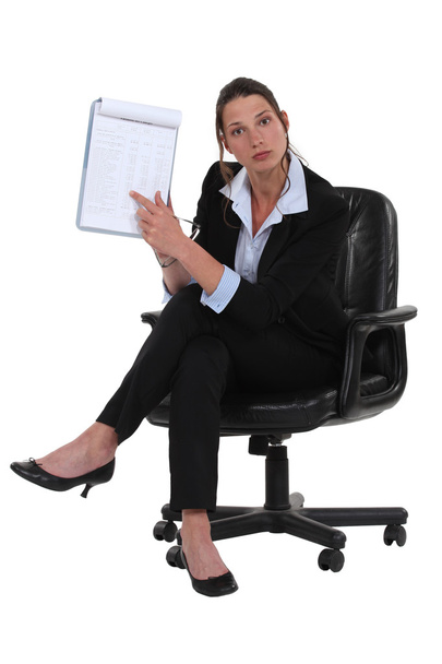 Businesswoman pointing at notepad - Foto, afbeelding