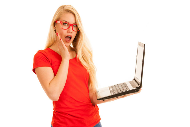 Beautiful young woman holds a laptop gesture surprise and succes - Foto, Imagem