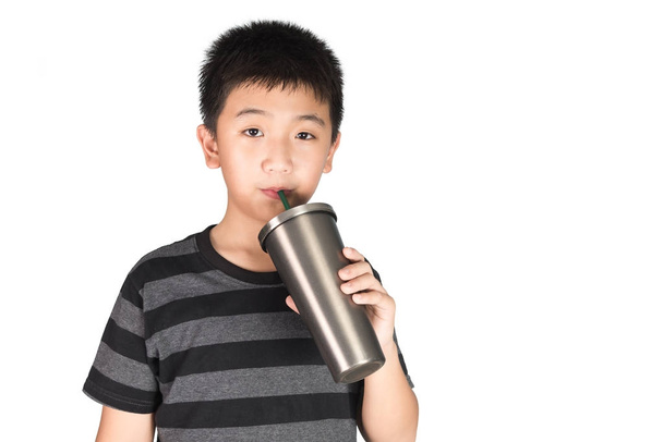 Asian kid boy holding stainless steel tumbler cup with straw, is - Foto, Imagem