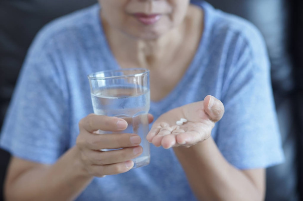 Elderly woman pill and glass of water Healthcare Medical - Foto, Imagen