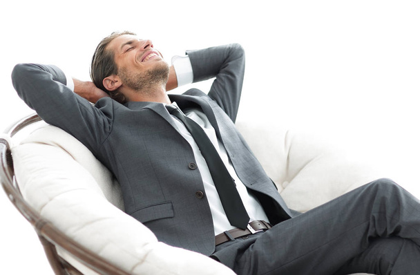 young businessman meditating in big comfortable armchair - Photo, Image