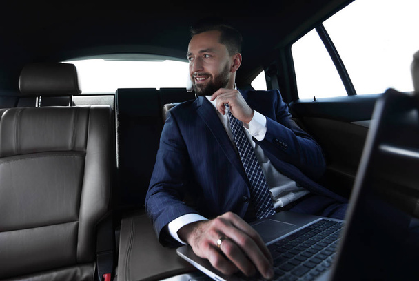 Confident businessman sitting in car - Фото, изображение