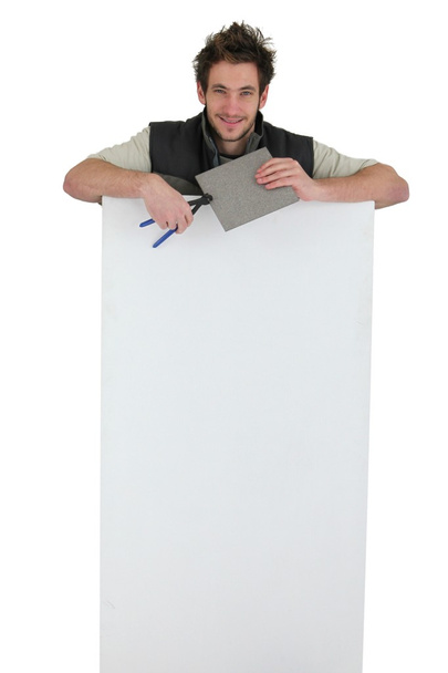 Tiler holding an ad board - 写真・画像