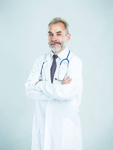 experienced therapist with a stethoscope on light background. - Fotó, kép