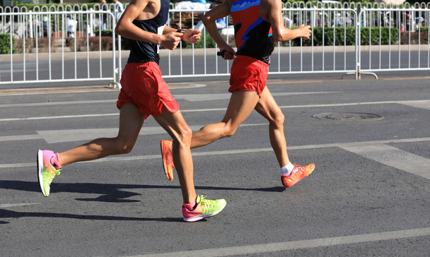 Marathon runners legs running on the road - Photo, Image
