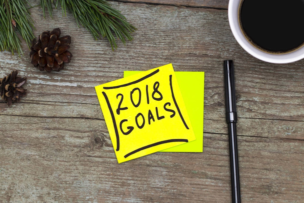 2018 goals - handwriting in black ink on a sticky note with a cu - Photo, Image