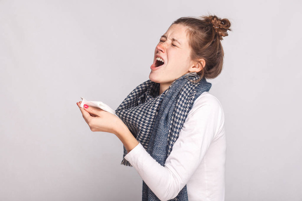 Sick woman holds a handkerchief and sneezes - Foto, Imagem