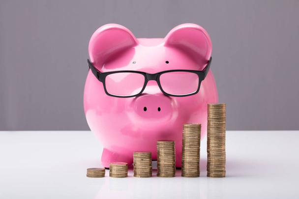 Piggybank And Stacked Coins - 写真・画像