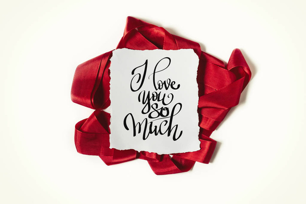 Inscription I love you so much. Red ribbon on white background - Photo, Image