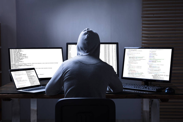 Hacker Using Multiple Computers  - Fotó, kép