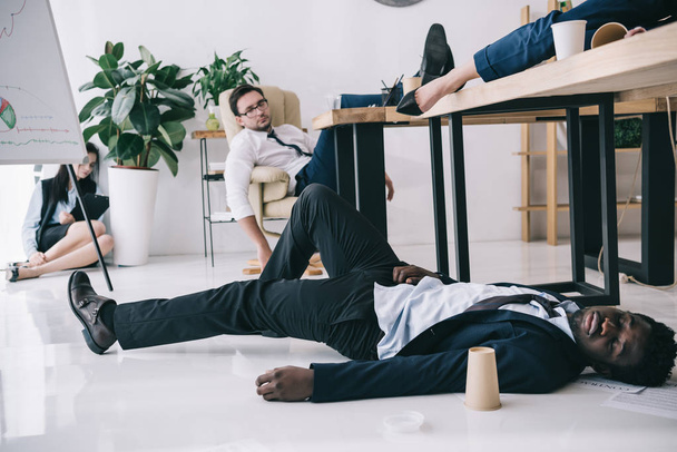exhausted businesspeople sleeping in conference hall at office - Photo, image