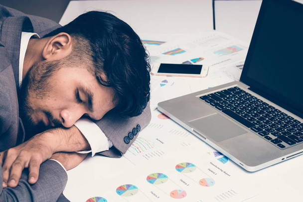 Tired businessman sleeping on workdesk - Foto, immagini