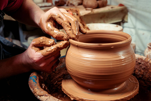 仕事で陶芸家します。ワーク ショップ。円の土製の瓶を作成、陶工の手 - 写真・画像