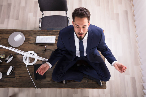 Businessman Doing Yoga In Office - Photo, Image
