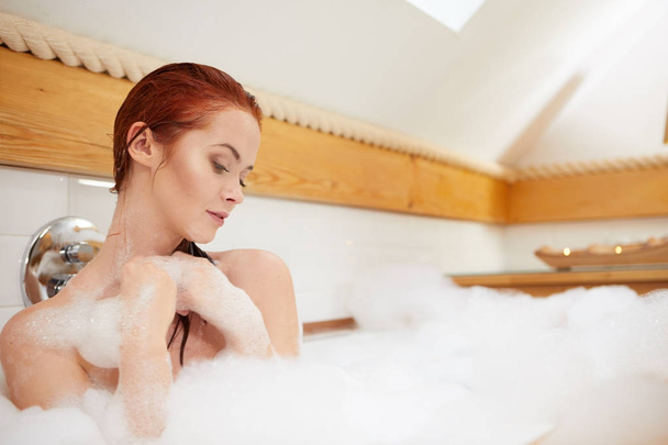 Beautiful woman in a bubble bath - 写真・画像
