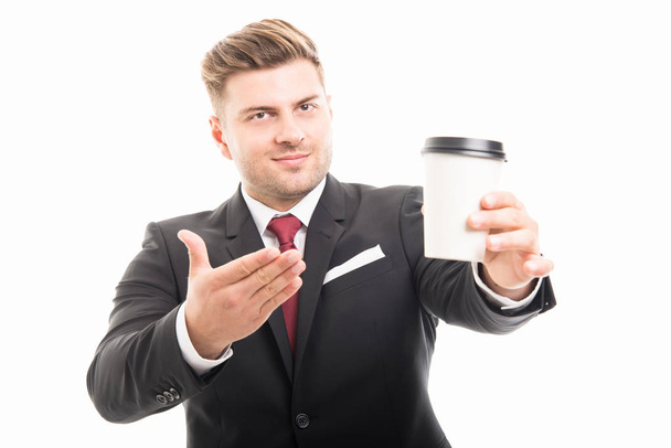 Business man standing showing takeaway coffee cup - Foto, imagen