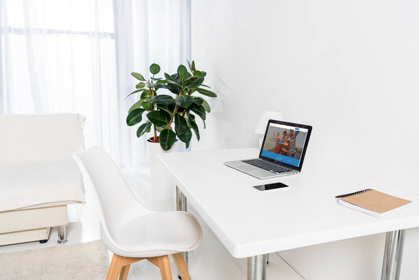 home office with laptop, smartphone and notebook on table - Foto, Imagen