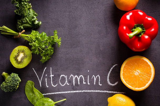 Ovoce a zeleniny bohaté na vitamín C s bílým slovo nápis křídou a kopírovat místem na černé břidlice. - Fotografie, Obrázek
