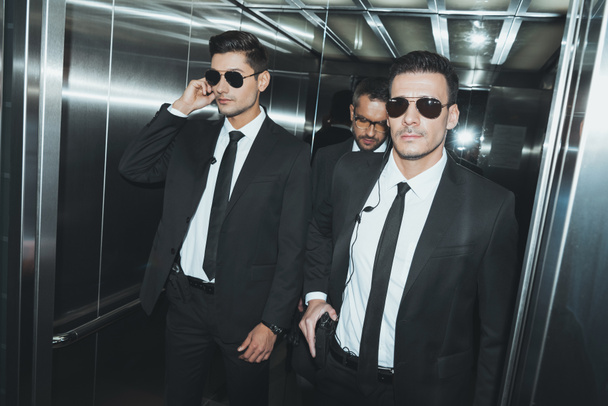 two bodyguards and politician standing in elevator - Zdjęcie, obraz