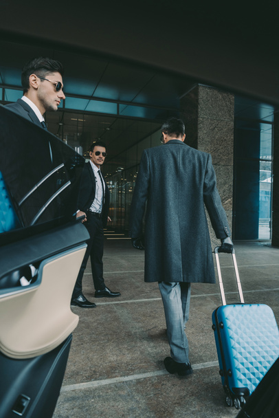 businessman going with blue travel bag to airport   - Fotó, kép