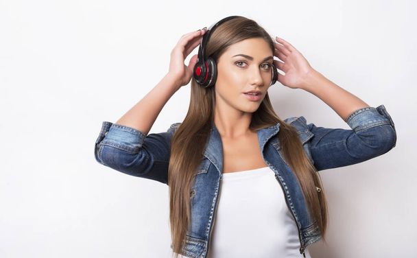 beautiful young woman with long hair listening to music with headphones - Photo, Image
