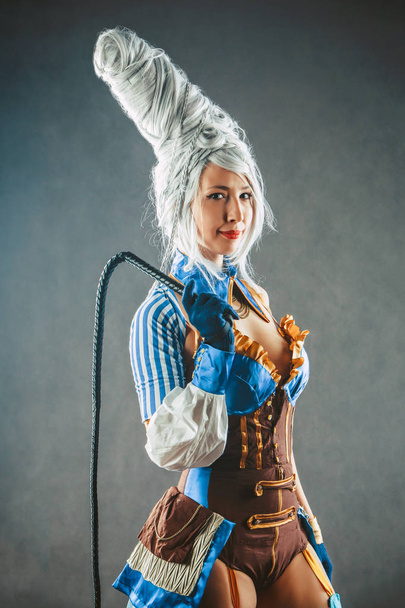 Beautiful woman trainer with the whip in a sexy circus suit - Valokuva, kuva