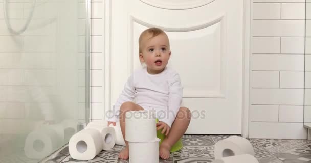 Baby sitting chamberpot his legs hanging down pot - Footage, Video