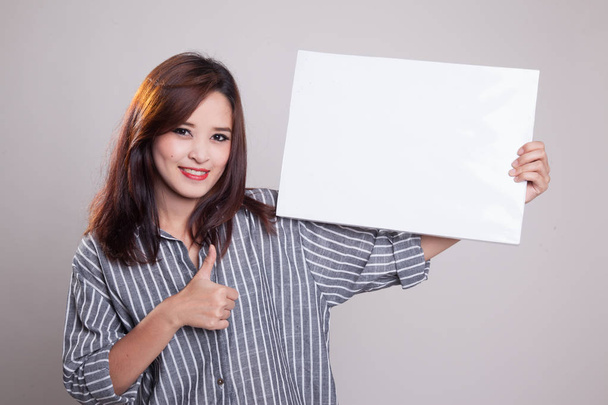 Young Asian woman show thumbs up with  white blank sign. - Fotoğraf, Görsel
