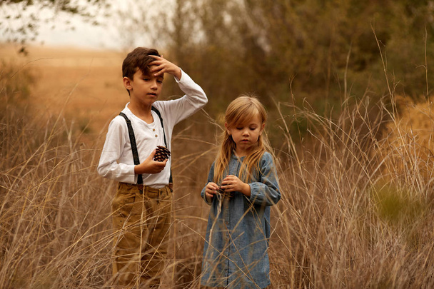 Little girl and boy outdoors - Фото, зображення