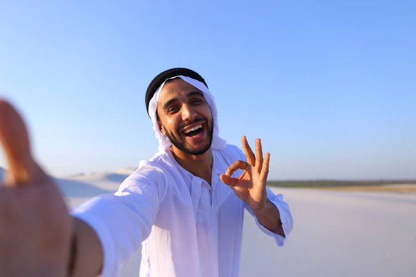 Happy portrait of male Arab who smiles and rejoices life, standi - Photo, Image