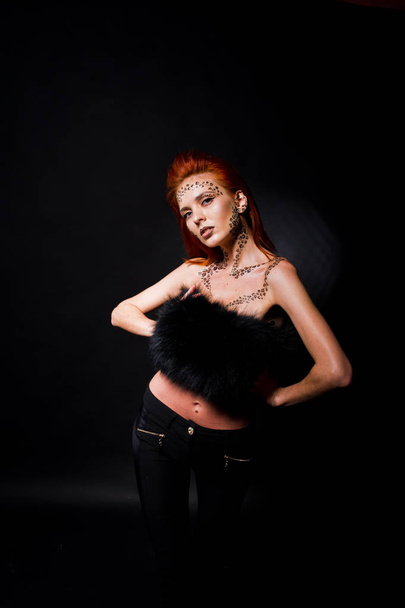 Fashion model red haired girl with originally make up like leopa - 写真・画像