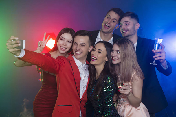 Cool friends. A company of happy friends at the party make a selfie photo with champagne. New Year. Birthday. Christmas. - Fotó, kép