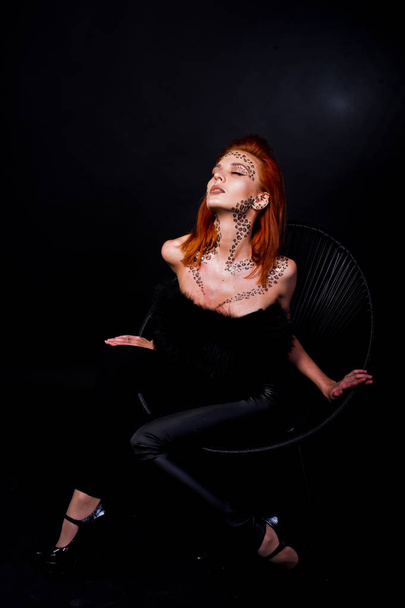 Fashion model red haired girl with originally make up like leopa - Foto, imagen