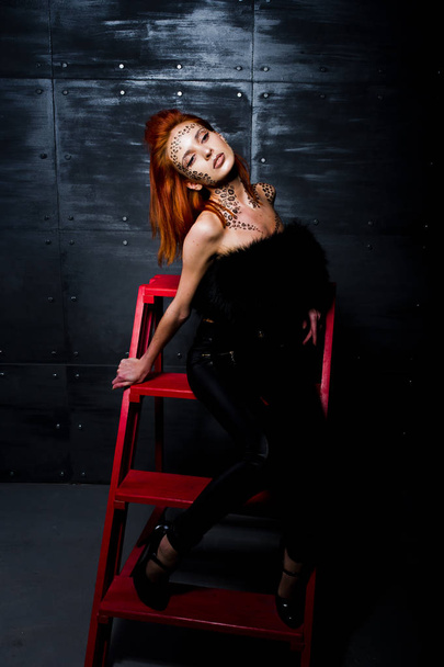Fashion model red haired girl with originally make up like leopa - Foto, Imagen