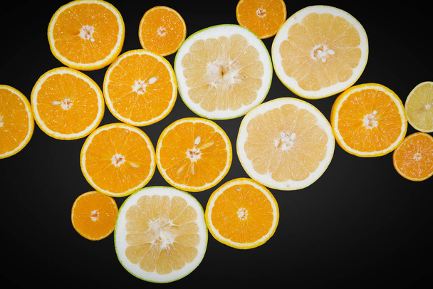 Citrus fruits (orange, lemon, grapefruit, mandarin, lime) isolated on black with clipping path. Fruit food background. Fresh citrus fruit assortment - Photo, Image