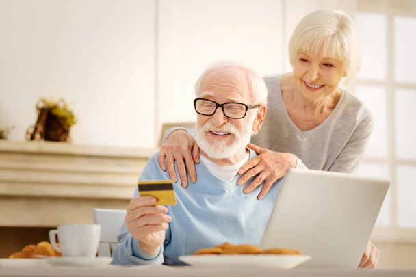 Joyful pensioner going to pay for his order - Φωτογραφία, εικόνα
