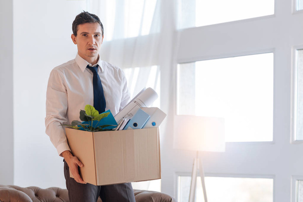 Exhausted disappointed man coming home after losing his job - Photo, Image