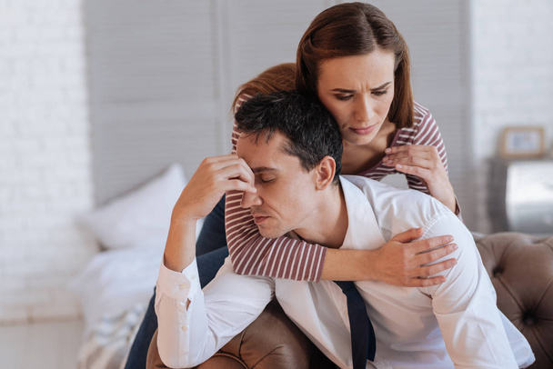 Kind loving woman hugging her exhausted depressed husband - Photo, image
