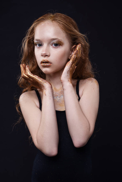 Cute redhead teenage model with bright makeup and colorful glitter and sparkles on her face and body. - Photo, image