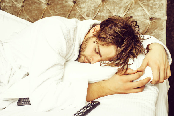 bearded man on bed with remote - Foto, Imagem