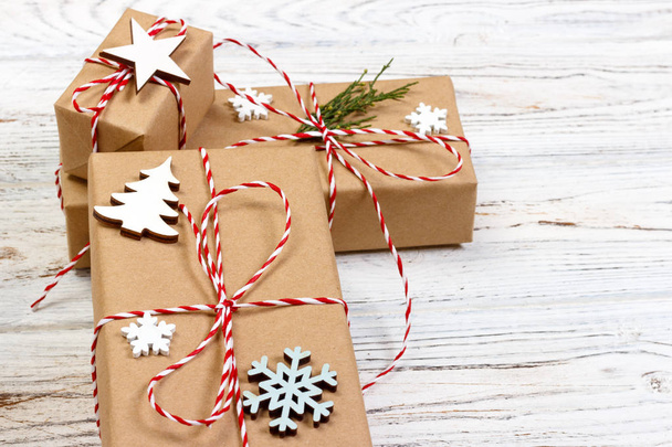 Christmas gifts with snowflakes, star and wooden christmas tree. New Year concept - Photo, Image