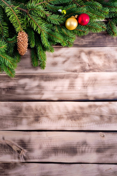Christmas fir tree on natural wooden background. - Foto, Imagen