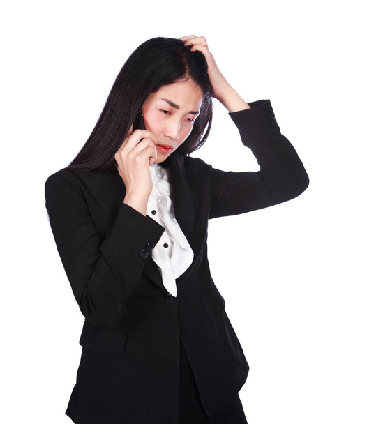 woman in business suit working in stress desperate talking on a  - 写真・画像