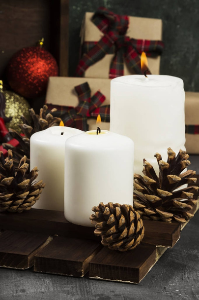 Burning candles and Christmas attributes on a dark background - Photo, image