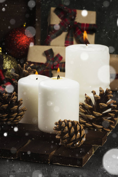Burning candles and Christmas attributes on a dark background. S - Photo, image